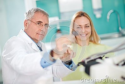 Male dentist looking patientâ€™s snapshot of teeth Stock Photo